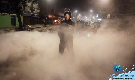 A policeman in riot gear stands guard in Tottenham